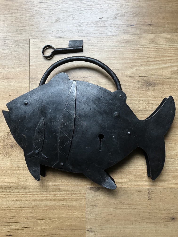 Large metal lock in the shape of a large fish, great and unique