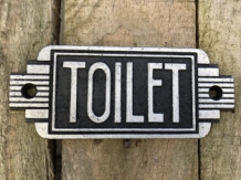 Cast iron sign ''Toilet'' in front of door