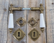 Set of door handles with rosettes - patinated brass 
